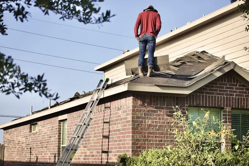 Professional roofer working on a residential roof in Rockwell Estates